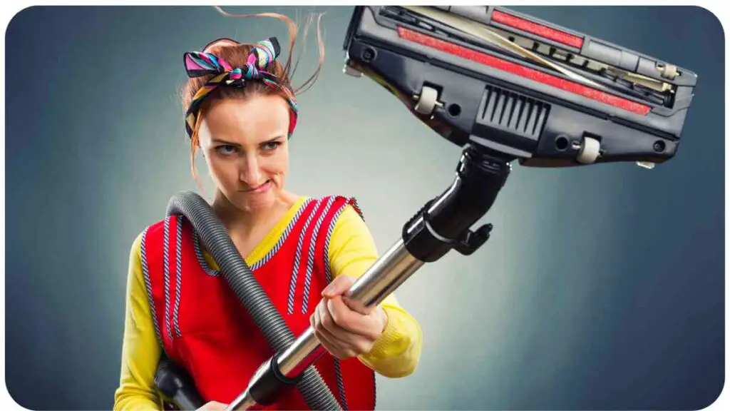 a person in an apron holding a vacuum cleaner